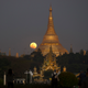 The moon rises behind Myanmar landmark Shwedagon pagoda, Wednesday, Jan.31.